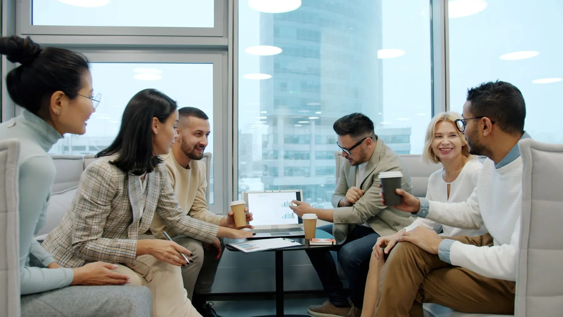 A team in a working session in a bright office lounge.